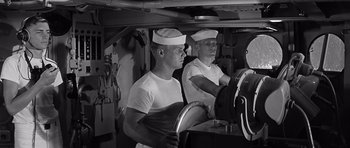 Movie still from “In Harm's Way” (1965), directed by Otto Preminger – Two men in white shirts and white hats on a boat; Medium shot, Low angle