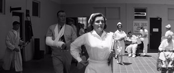 Movie still from “In Harm's Way” (1965), directed by Otto Preminger – An old black and white photo of a man and a woman; Medium shot, Low angle