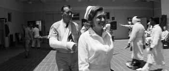 Movie still from “In Harm's Way” (1965), directed by Otto Preminger – An old photo of a man and a woman; Medium shot, Low angle