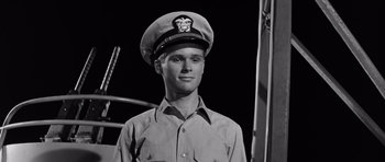 Movie still from “In Harm's Way” (1965), directed by Otto Preminger – Black and white photograph of a man in a sailor's uniform; Close Up shot, Low angle