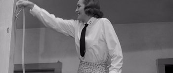 Movie still from “In Harm's Way” (1965), directed by Otto Preminger – A woman wearing a dress shirt and a tie; Medium shot, Low angle