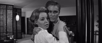 Movie still from “In Harm's Way” (1965), directed by Otto Preminger – A man and a woman embracing each other in black and white; Close Up shot, Low angle