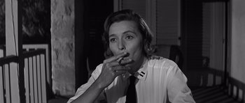 Movie still from “In Harm's Way” (1965), directed by Otto Preminger – A black and white photo of a woman smoking a cigarette; Close Up shot, Low angle