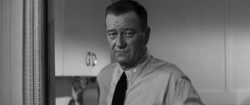 Movie still from “In Harm's Way” (1965), directed by Otto Preminger – An older man wearing a shirt and a tie; Close Up shot, Low angle