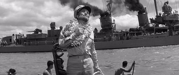 Movie still from “In Harm's Way” (1965), directed by Otto Preminger – An old man in a uniform standing in front of a ship; Medium shot, Low angle