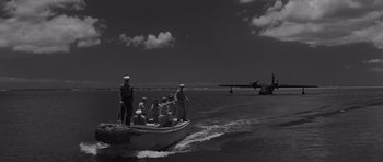 Movie still from “In Harm's Way” (1965), directed by Otto Preminger – A group of people on a boat in the water; Extreme Wide shot, Low angle