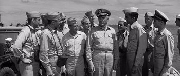 Movie still from “In Harm's Way” (1965), directed by Otto Preminger – A group of men standing next to each other on top of a boat; Medium shot, Low angle