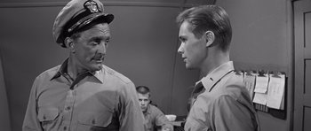 Movie still from “In Harm's Way” (1965), directed by Otto Preminger – Two men in uniform talking to one another; Close Up shot, Over the shoulder angle