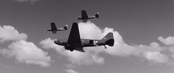 Movie still from “In Harm's Way” (1965), directed by Otto Preminger – A group of planes flying through the sky; Wide shot, Low angle