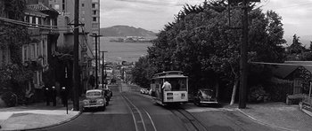 Movie still from “In Harm's Way” (1965), directed by Otto Preminger – A black - and - white photo of a tram on a street; Extreme Wide shot, High angle