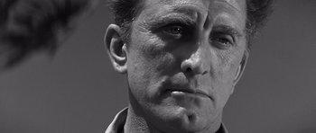Movie still from “In Harm's Way” (1965), directed by Otto Preminger – Black and white photograph of a man's face; Close Up shot, Low angle