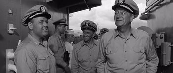 Movie still from “In Harm's Way” (1965), directed by Otto Preminger – A black and white photo of a group of men in uniform; Medium shot, Low angle