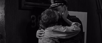 Movie still from “In Harm's Way” (1965), directed by Otto Preminger – A couple of people that are kissing in a room; Close Up shot, Low angle