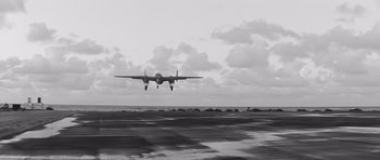 Movie still from “In Harm's Way” (1965), directed by Otto Preminger – An airplane is flying low over the ocean; Extreme Wide shot, Low angle