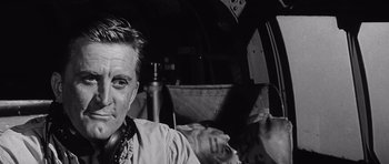 Movie still from “In Harm's Way” (1965), directed by Otto Preminger – A black and white photo of a man in a helicopter; Close Up shot, Low angle