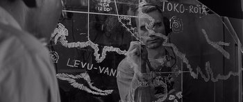 Movie still from “In Harm's Way” (1965), directed by Otto Preminger – A man standing in front of a wall with a map on it; Close Up shot, High angle