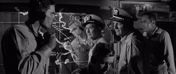 Movie still from “In Harm's Way” (1965), directed by Otto Preminger – A black and white photo of a group of men in uniform; Medium shot, High angle