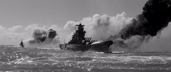 Movie still from “In Harm's Way” (1965), directed by Otto Preminger – A large boat in the water with smoke coming out of it; Extreme Wide shot, High angle