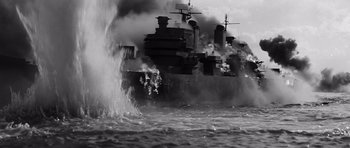 Movie still from “In Harm's Way” (1965), directed by Otto Preminger – A black and white photo of a ship in the water; Extreme Wide shot, High angle
