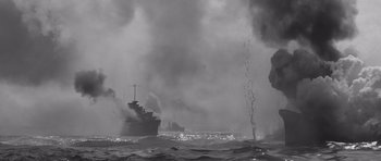 Movie still from “In Harm's Way” (1965), directed by Otto Preminger – A large ship in the ocean with smoke billowing from it; Extreme Wide shot, Low angle