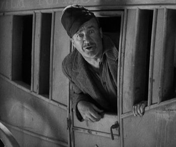 Movie still from “In Old Arizona” (1928), directed by Raoul Walsh – An old photo of a man looking out of a window; Medium shot, Low angle