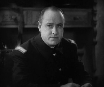 Movie still from “In Old Arizona” (1928), directed by Raoul Walsh – Black and white photograph of a man in military uniform; Close Up shot, Low angle