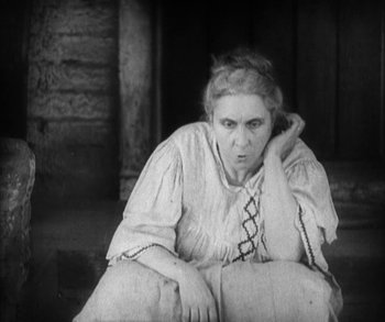 Movie still from “In Old Arizona” (1928), directed by Raoul Walsh – An old photo of a woman sitting on the ground; Medium shot, High angle