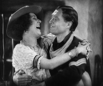 Movie still from “In Old Arizona” (1928), directed by Raoul Walsh – An old photo of a man and a woman dancing; Medium shot, High angle