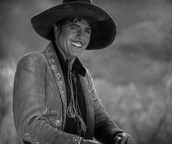 Movie still from “In Old Arizona” (1928), directed by Raoul Walsh – An old photo of a man wearing a cowboy hat; Medium shot, Low angle