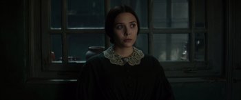 Movie still from “In Secret” (2013), directed by Charlie Stratton – A woman in a black dress and a lace collar; Close Up shot, Over the shoulder angle