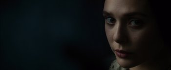 Movie still from “In Secret” (2013), directed by Charlie Stratton – A woman's face in the dark; Close Up shot, Over the shoulder angle