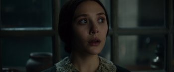 Movie still from “In Secret” (2013), directed by Charlie Stratton – A young woman looking up into the air; Close Up shot, Low angle