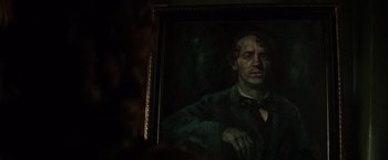 Movie still from “In Secret” (2013), directed by Charlie Stratton – A painting of a man in a dark room; Close Up shot, Over the shoulder angle