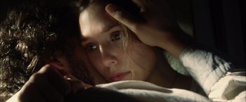 Movie still from “In Secret” (2013), directed by Charlie Stratton – A person laying in a bed; Extreme Close Up shot, Overhead angle