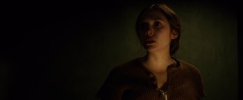 Movie still from “In Secret” (2013), directed by Charlie Stratton – A woman is standing in a dark room; Close Up shot, Low angle