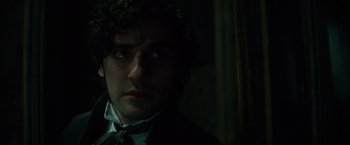 Movie still from “In Secret” (2013), directed by Charlie Stratton – A person wearing a suit and tie; Close Up shot, Over the shoulder angle