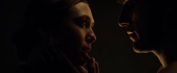 Movie still from “In Secret” (2013), directed by Charlie Stratton – A woman is looking into the distance in the dark; Close Up shot, Low angle