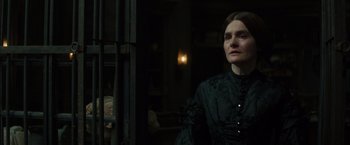 Movie still from “In Secret” (2013), directed by Charlie Stratton – A woman in a black dress looking out of a window; Close Up shot, Over the shoulder angle