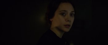 Movie still from “In Secret” (2013), directed by Charlie Stratton – A young woman is looking into the camera; Close Up shot, Over the shoulder angle