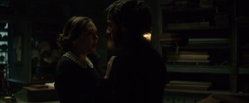 Movie still from “In Secret” (2013), directed by Charlie Stratton – A man and a woman in a dark room; Close Up shot, Over the shoulder angle