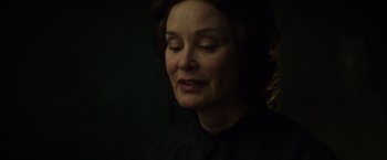 Movie still from “In Secret” (2013), directed by Charlie Stratton – A person wearing a black shirt; Close Up shot, Over the shoulder angle