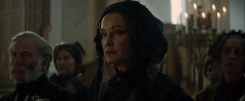 Movie still from “In Secret” (2013), directed by Charlie Stratton – An older woman wearing a black veil looking at the camera; Close Up shot, Over the shoulder angle