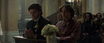 Movie still from “In Secret” (2013), directed by Charlie Stratton – A man and a woman sitting next to each other; Close Up shot, Low angle