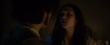 Movie still from “In Secret” (2013), directed by Charlie Stratton – A man and a woman looking at one another; Close Up shot, Over the shoulder angle