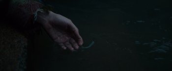Movie still from “In Secret” (2013), directed by Charlie Stratton – A person holding their hand out in the dark; Extreme Close Up shot, High angle