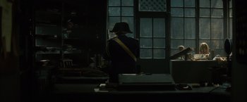 Movie still from “In Secret” (2013), directed by Charlie Stratton – A man in a uniform standing in front of an open window; Wide shot, Over the shoulder angle