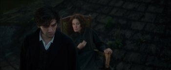 Movie still from “In Secret” (2013), directed by Charlie Stratton – A man and a woman sitting on a chair; Medium shot, High angle