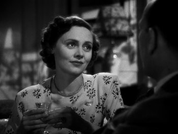 Movie still from “In Which We Serve” (1942), directed by Noël Coward – An old photo of a woman holding a wine glass; Close Up shot, Over the shoulder angle