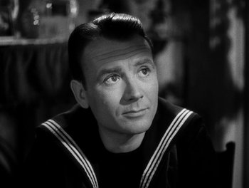 Movie still from “In Which We Serve” (1942), directed by Noël Coward – An older man in a sailor suit looking to his left; Close Up shot, High angle
