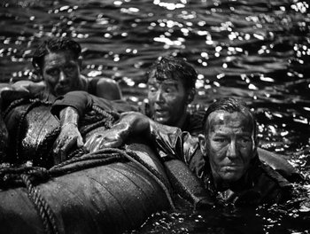 Movie still from “In Which We Serve” (1942), directed by Noël Coward – A group of men in a body of water; Medium shot, High angle